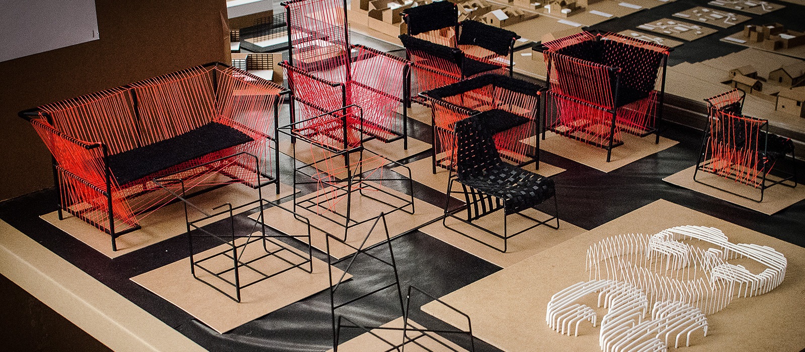 Fauteuils en fil rouge et noir sur socles, projet design mobilier École Bleue